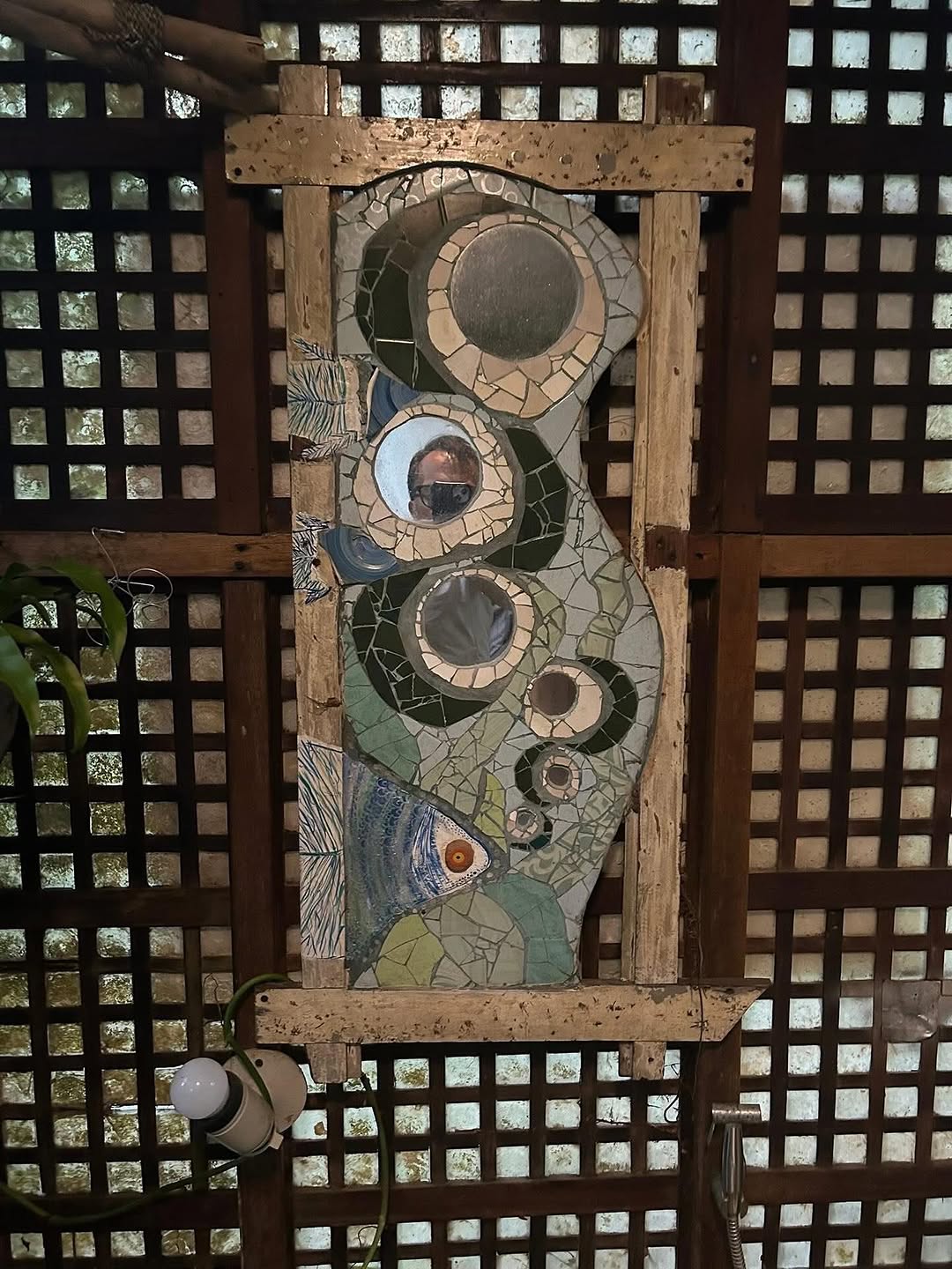 Open-air bathroom mosaic art at Kapusod